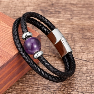 Detail of double-layer black braided leather bracelet with purple stone and magnetic clasp