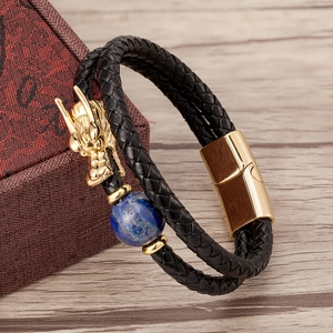 Detailed close-up of a double-layer black leather bracelet with a golden dragon and blue stone