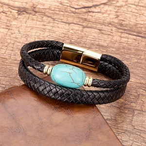Detail of hand-woven black leather bracelet with turquoise stone and magnetic gold clasp