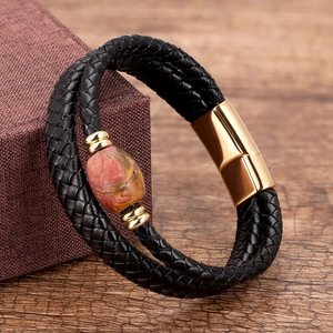 Close-up of double-layer black braided leather bracelet with red jasper and gold magnetic clasp