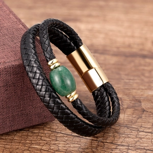 Detail of woven leather bracelet with green natural stone bead and gold magnetic clasp