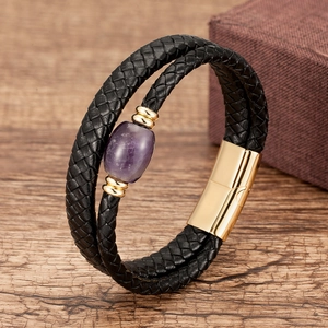 Detailed macro view of woven leather bracelet with purple gemstone and magnetic clasp