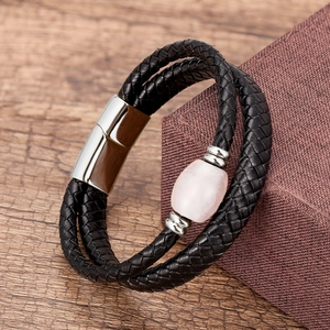 Detail of double-layer black woven leather bracelet with pink stone and magnetic clasp