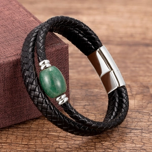 Detail of men's leather braided bracelet with green stone bead and silver magnetic clasp