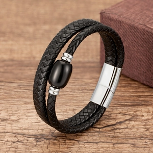 Close-up of black braided leather double-loop bracelet with silver magnetic metal clasp