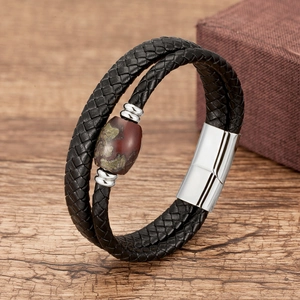 Close-up of a double-layer braided leather bracelet with natural stone bead and magnetic clasp