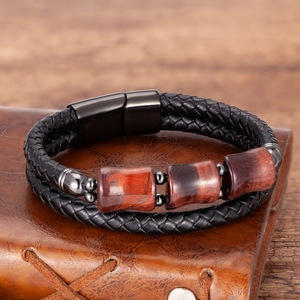 Close-up of double-layer woven leather bracelet with stone beads and magnetic metal clasp