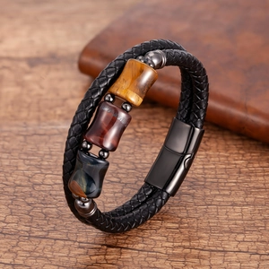 Close-up of men's multi-layer woven leather bracelet with tiger eye stones and magnetic clasp