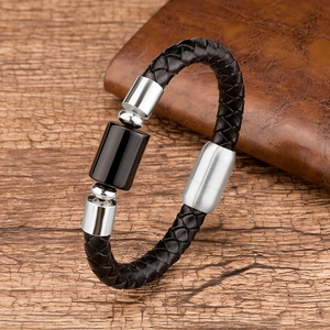 Close-up of black braided leather bracelet with stainless steel clasp and black stone bead