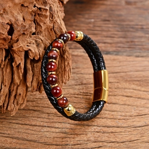 Close-up of double-layer black leather woven bracelet with tiger eye beads and magnetic clasp