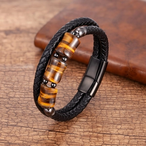 Close-up of triple tiger eye stones on black braided leather bracelet with magnetic clasp