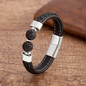 Détail d'un bracelet en cuir tressé noir avec perles de lave et fermoir en métal argenté