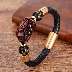 Braided leather Pixiu bracelet with gold magnetic clasp and black beads in macro view