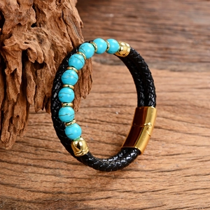 Detail of black woven leather bracelet with turquoise beads and gold magnetic clasp