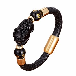 Braided leather bracelet with golden Pi Xiu charm and obsidian beads on white background