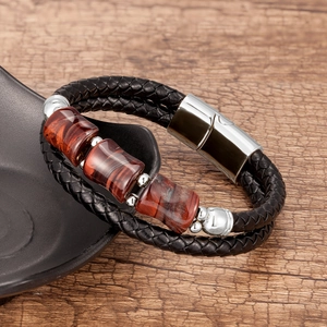 Detail of double-layer black braided leather bracelet with tiger eye stone and magnetic clasp