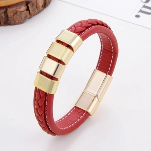 Detail of red braided leather bracelet with gold magnetic clasp and square metal beads