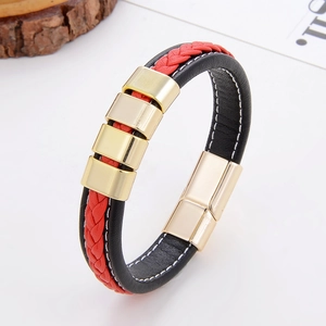 Detail of red and black braided leather bracelet featuring gold magnetic clasp and sliders