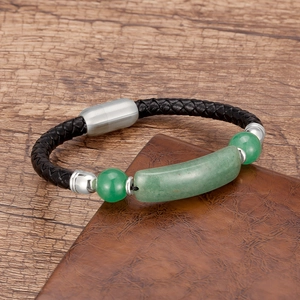 Close-up of woven black leather bracelet with green stone beads and magnetic metal clasp
