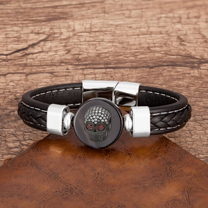 Close-up of leather punk bracelet with skull head ornament and sparkling crystals