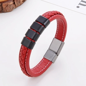 Detail of red braided leather bracelet with black accents and metallic magnetic clasp