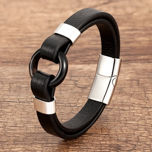 Detail view of multi-layer black braided leather bracelet with silver metal magnetic clasp