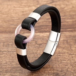 Detail view of black double leather bracelet with pink resin ring and magnetic silver clasp
