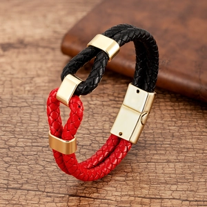Detail of red and black braided leather bracelet with gold magnetic metal clasp