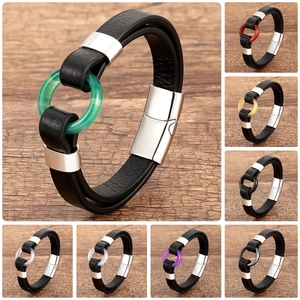 Detail of braided leather bracelet featuring colorful resin rings and magnetic metal clasp