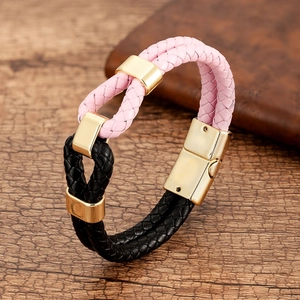 Detail of pink and black woven leather bracelet with polished gold magnetic clasp