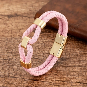 Detail of pink woven leather bracelet featuring polished gold buckles and a magnetic clasp