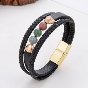 Macro detail of men's leather bracelet with tricolor stone beads and gold magnetic clasp