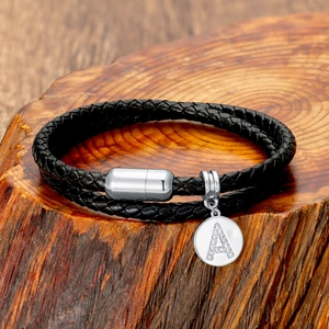 Close-up of double-layer braided leather bracelet featuring a crystal A-letter pendant