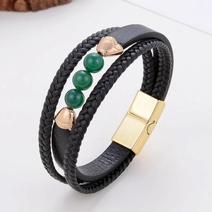 Detail view of multi-layer leather bracelet with green beads and gold magnetic clasp