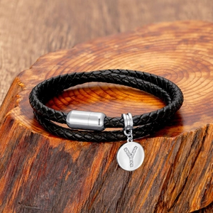 Close-up of black braided leather bracelet with silver magnetic clasp and letter Y charm