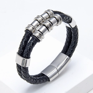 Detail of black double-layered braided leather bracelet with silver magnetic metal clasp