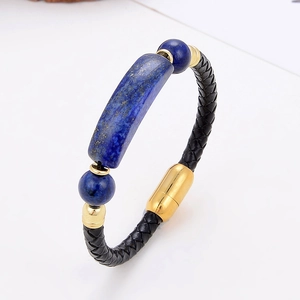 Detail view of woven black leather bracelet featuring lapis lazuli and gold magnetic clasp