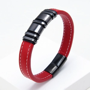 Detail showing red woven leather texture with white stitching and gunmetal magnetic clasp