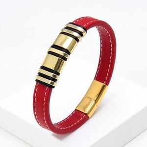 Detail of red braided leather bracelet featuring golden metal tubes and magnetic clasp