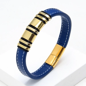 Detail of blue braided leather bracelet featuring gold magnetic clasp and metal ring charms
