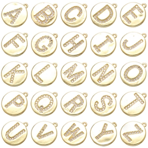 Detail of 25 gold-plated round letter charms with white crystal rhinestone inlay