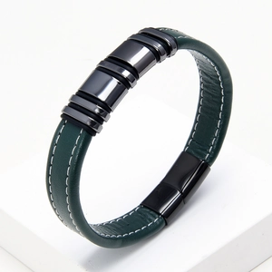 Detailed macro view of dark green braided leather bracelet with black magnetic clasp