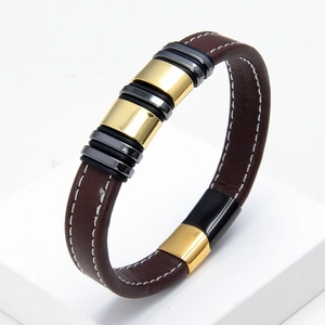 Detailed side view of braided brown leather bracelet with gold and black metal rings