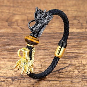 Detail of men's leather braided bracelet with dragon heads and tiger eye stone bead