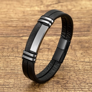 Detail of men's double-layer black leather bracelet with steel decor and magnetic clasp