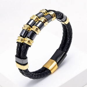 Detail view of double-layer woven leather bracelet with gold and gunmetal decorative beads