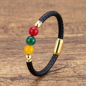 Detail of multi-strand black braided leather bracelet with tri-color beads and gold magnetic clasp