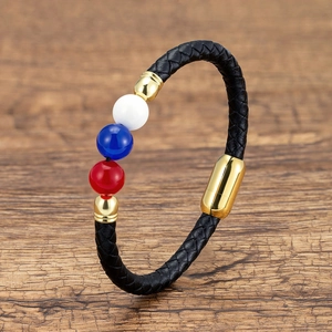 Detail view of black braided leather bracelet with gold magnetic clasp and colored beads