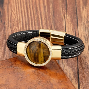 Dettaglio del bracciale con pietra occhio di tigre tonda placcato oro e pelle nera