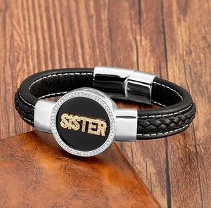 Detail of hand-woven black leather bracelet with crystal SISTER charm and magnetic clasp